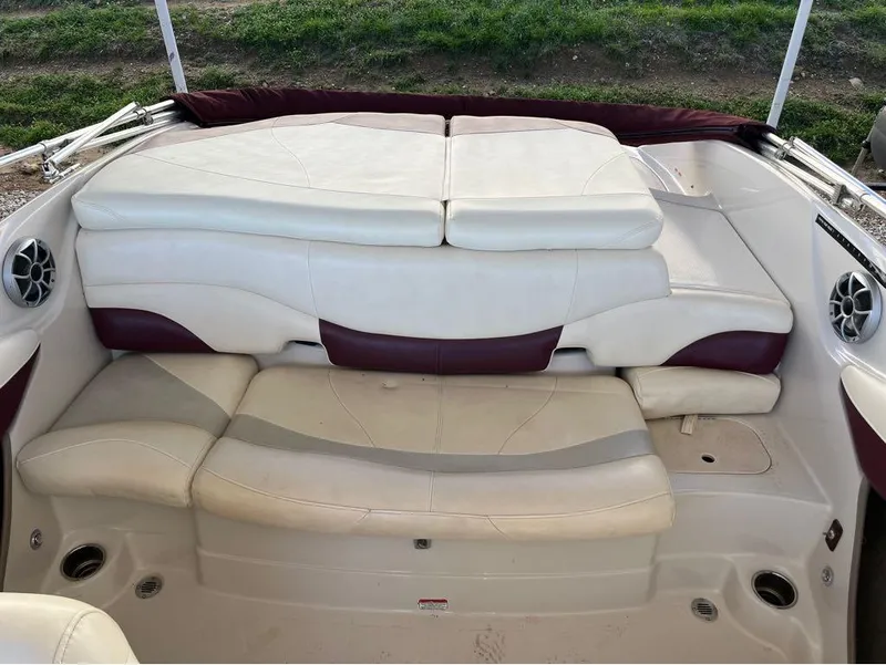 Slide: The Image of 2009 Tahoe Q71SSF boat interior with white and maroon seating, featuring built-in speakers. - 7