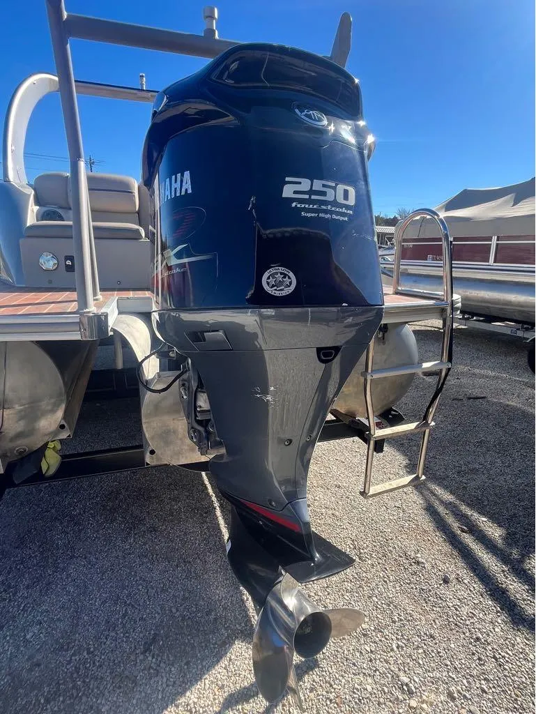 Slide: The Image of Outboard motor on a 2013 Berkshire 250 Sport BP3 pontoon boat, sunny day. - 4