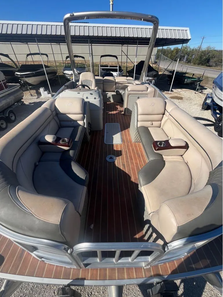 Slide: The Image of 2013 Berkshire 250 Sport BP3 pontoon boat with spacious seating and wood-style flooring. - 6