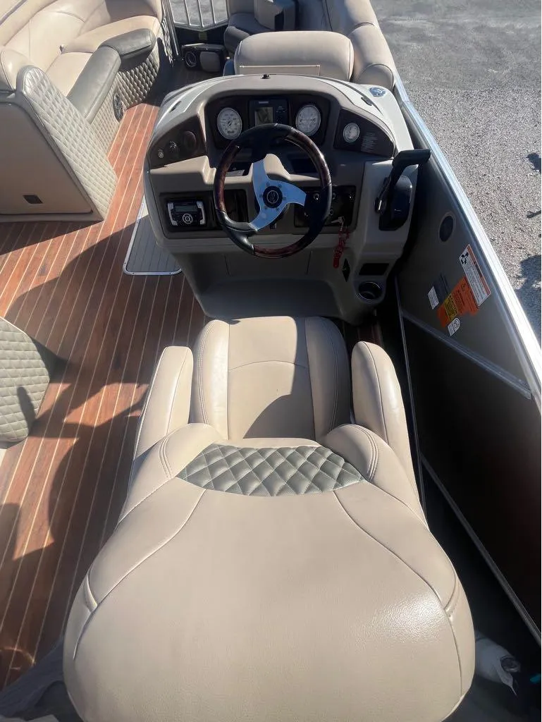 Slide: The Image of 2013 Berkshire 250 Sport BP3 boat interior with beige seating and steering console. - 9