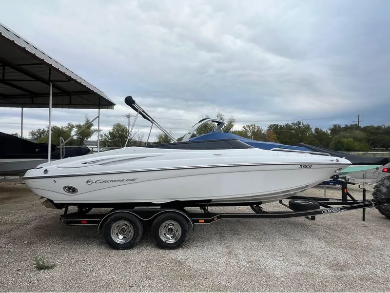 Slide: The Image of 2007 Crownline 23 SS LPX boat on trailer, parked outdoors under cloudy sky. - 3
