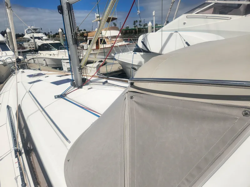 Slide: The Image of 2013 Beneteau Oceanis 41 sailboat docked at marina, showcasing deck and rigging. - 11
