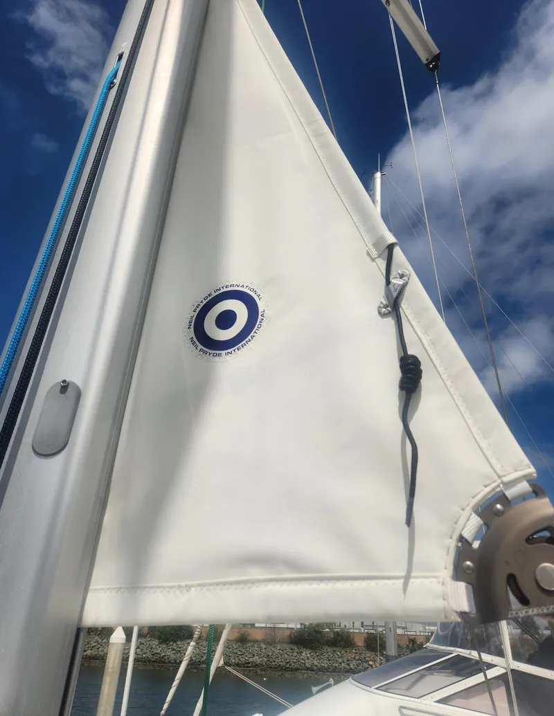 Slide: The Image of 2013 Beneteau Oceanis 41 sailboat mast and sail under clear blue sky. - 12