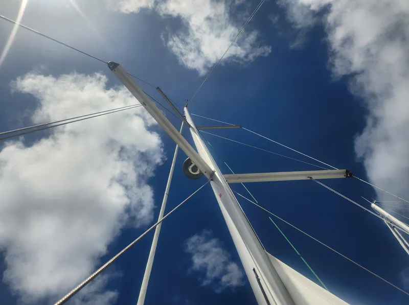 Slide: The Image of Looking up at the mast of a 2013 Beneteau Oceanis 41 sailboat against a blue sky. - 13