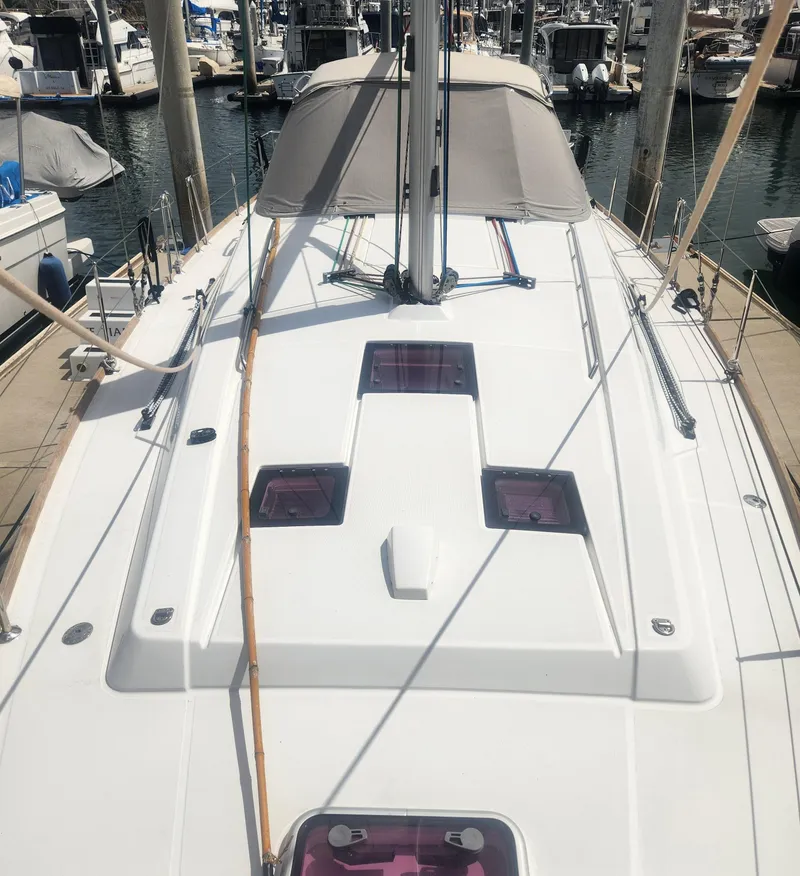 Slide: The Image of 2013 Beneteau Oceanis 41 sailboat docked at marina, showcasing sleek deck design. - 15