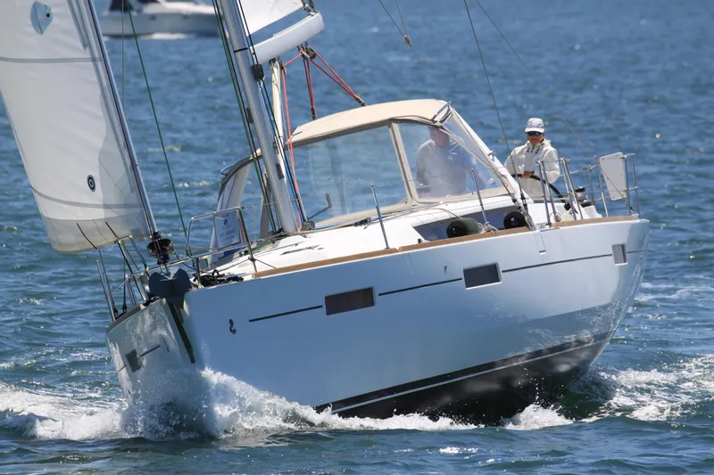 Slide: The Image of 2013 Beneteau Oceanis 41 sailboat navigating through blue waters. - 2