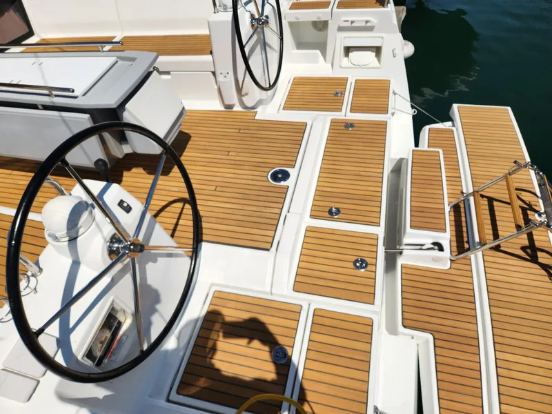 Slide: The Image of Beneteau Oceanis 41 (2013) yacht deck with dual steering wheels and teak flooring. - 20