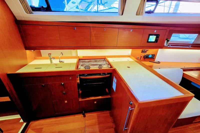 Slide: The Image of Interior of 2013 Beneteau Oceanis 41 yacht kitchen with wood cabinetry and modern appliances. - 25