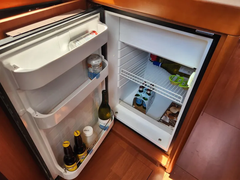 Slide: The Image of Open fridge in 2013 Beneteau Oceanis 41 yacht, stocked with drinks and food. - 29