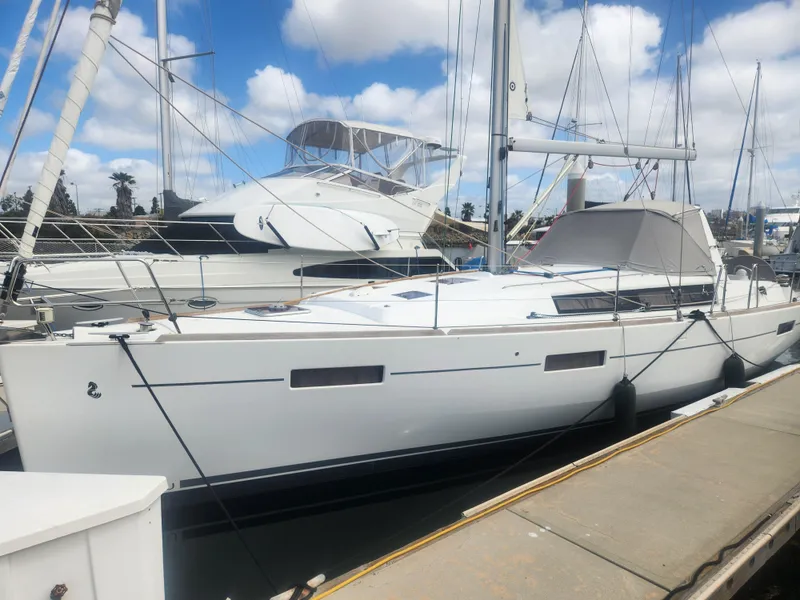 Slide: The Image of 2013 Beneteau Oceanis 41 sailboat docked at marina under blue sky. - 3