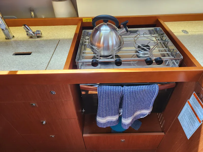 Slide: The Image of Galley kitchen in 2013 Beneteau Oceanis 41 yacht with stove and kettle. - 30