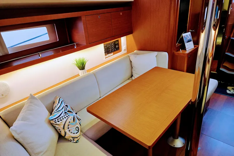 Slide: The Image of Interior of 2013 Beneteau Oceanis 41 yacht with cozy seating and wooden table. - 35