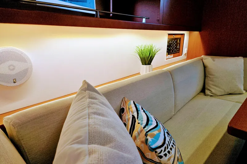 Slide: The Image of Interior of 2013 Beneteau Oceanis 41 yacht with cozy seating and decorative pillows. - 36