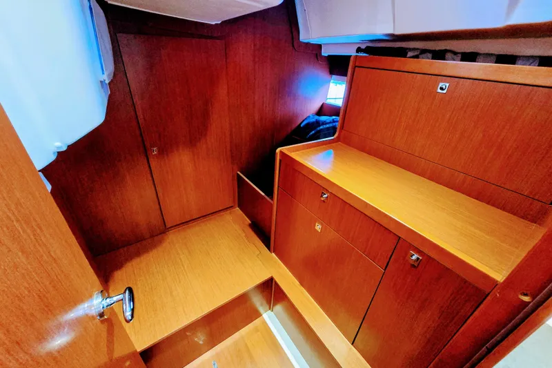 Slide: The Image of Interior of 2013 Beneteau Oceanis 41 sailboat with wooden cabinetry and storage. - 39