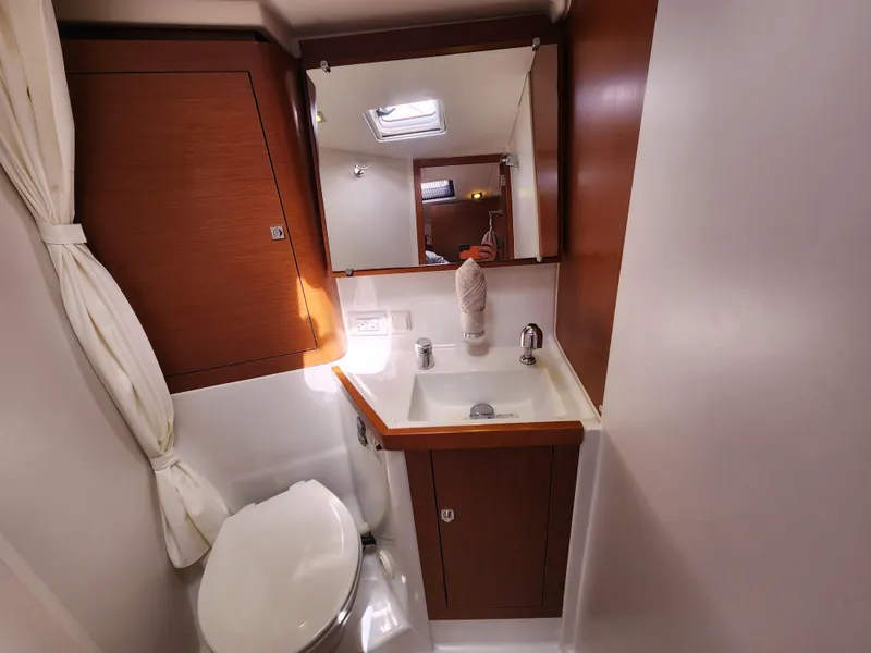 Slide: The Image of Bathroom interior of 2013 Beneteau Oceanis 41 yacht, featuring sink, mirror, and toilet. - 40