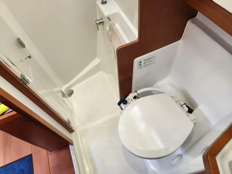 Slide: The Image of Compact bathroom in 2013 Beneteau Oceanis 41 yacht, featuring a toilet and shower area. - 42