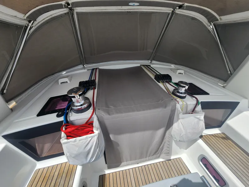 Slide: The Image of 2013 Beneteau Oceanis 41 cockpit with winches, ropes, and teak flooring. - 7