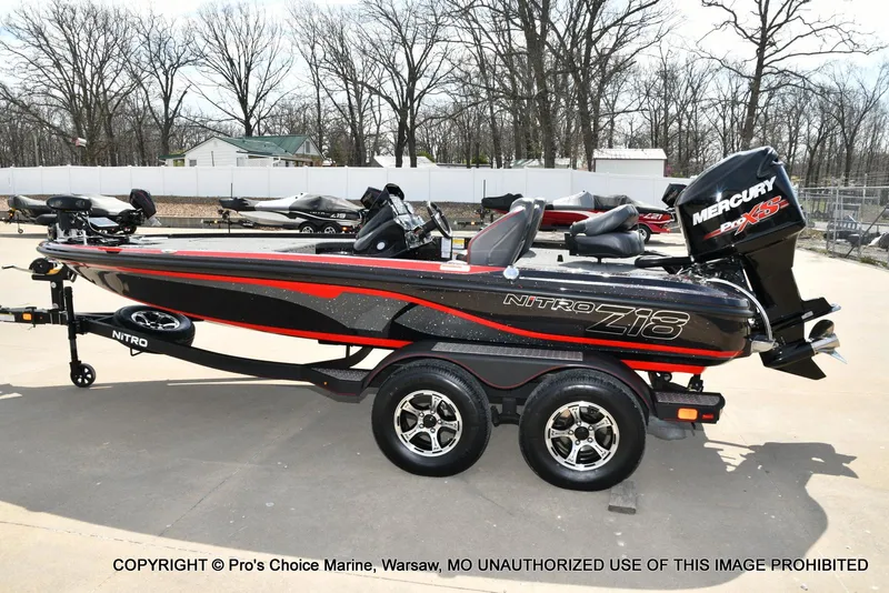 Slide: The Image of 2018 Nitro Z18 Pro boat with 175 Pro-XS engine on trailer, parked outdoors. - 27