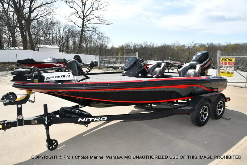 Slide: The Image of 2018 Nitro Z18 Pro boat with 175 Pro-XS engine on trailer, parked outdoors. - 28