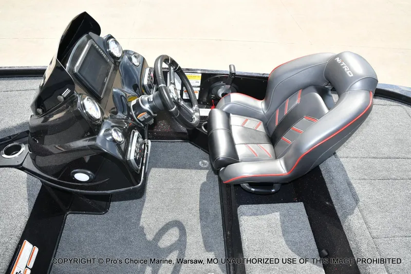 Slide: The Image of 2018 Nitro Z18 Pro boat cockpit with steering wheel and cushioned seat. - 45