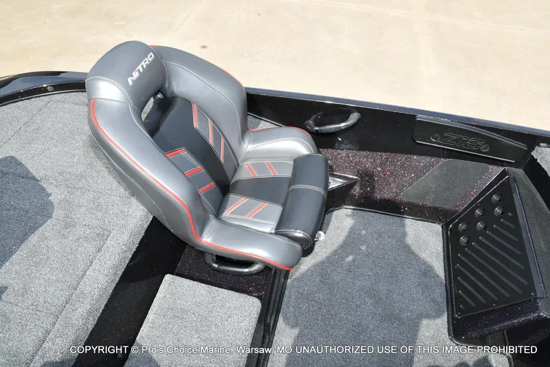 Slide: The Image of 2018 Nitro Z18 Pro boat seat with gray and red accents, featuring carpeted flooring. - 47
