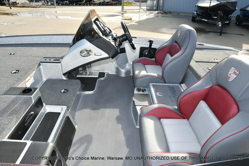 Slide: The Image of 2024 Triton 18 TRX boat interior with dual seats and control console. - 10
