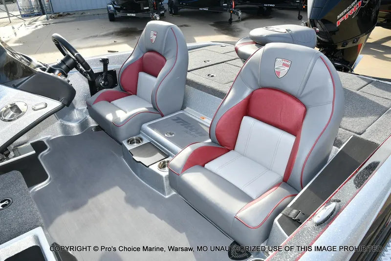 Slide: The Image of 2024 Triton 18 TRX boat interior with gray and red seats, steering wheel, and console. - 11