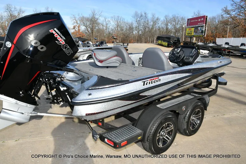 Slide: The Image of 2024 Triton 18 TRX boat with 200 Pro-XS engine on a trailer, parked outdoors. - 13