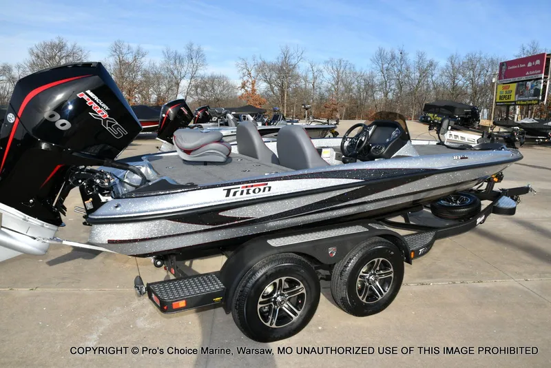 Slide: The Image of 2024 Triton 18 TRX boat with 200 Pro-XS engine on a trailer, parked outdoors. - 14