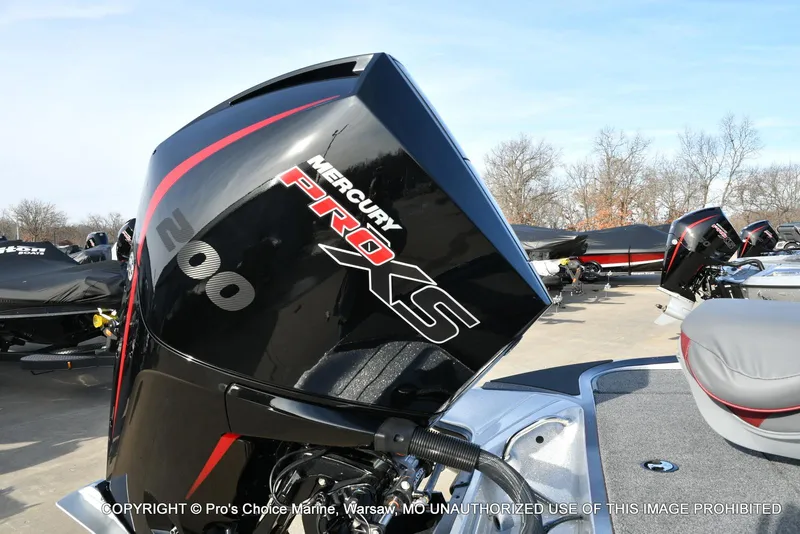 Slide: The Image of 2024 Triton 18 TRX boat with Mercury 200 Pro-XS engine, parked outdoors. - 16
