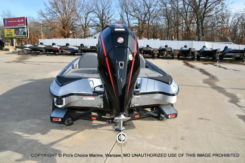 Slide: The Image of 2024 Triton 18 TRX w/200 Pro-XS boat displayed outdoors on a concrete lot. - 19