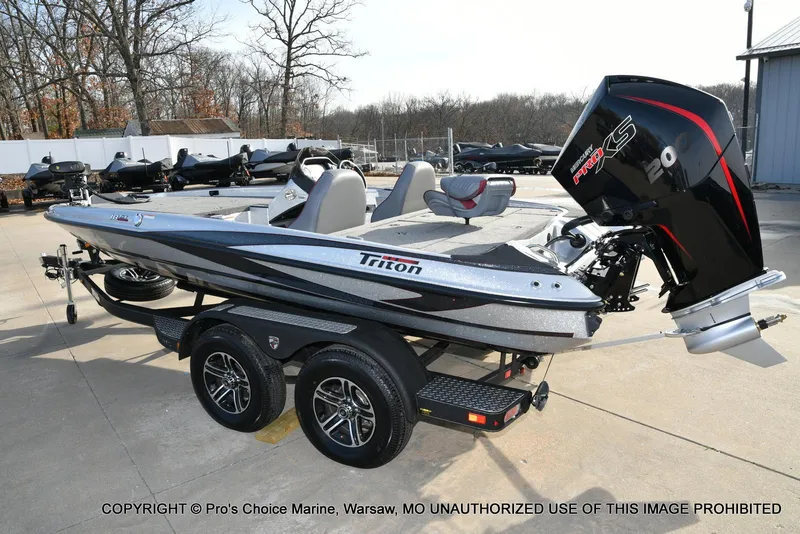 Slide: The Image of 2024 Triton 18 TRX boat with 200 Pro-XS engine on trailer, outdoor setting. - 20