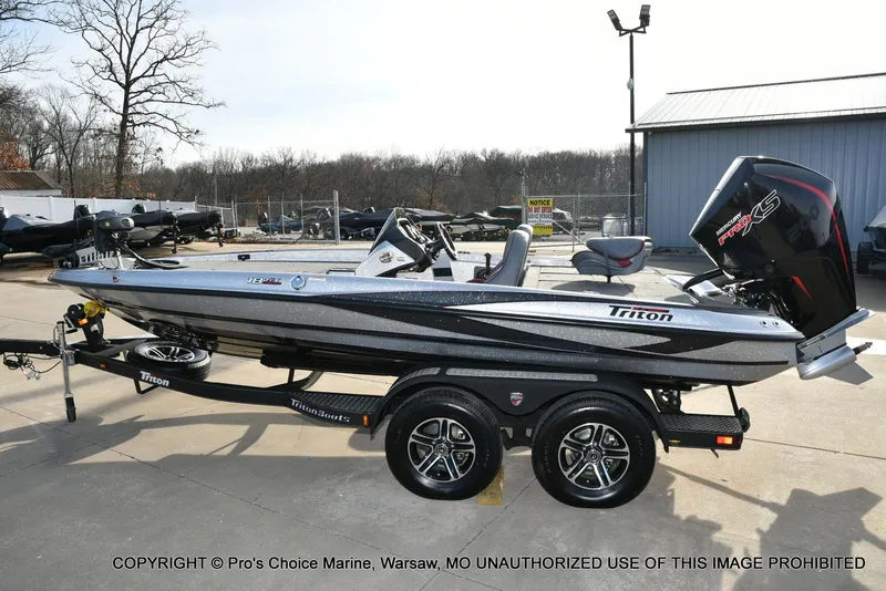 Slide: The Image of 2024 Triton 18 TRX boat with 200 Pro-XS engine on a trailer in a marina. - 21