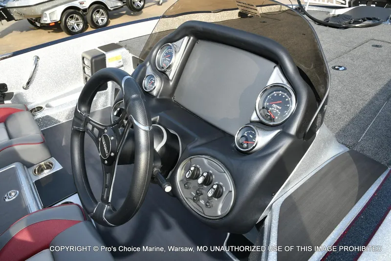 Slide: The Image of 2024 Triton 18 TRX boat dashboard with steering wheel and gauges. - 29