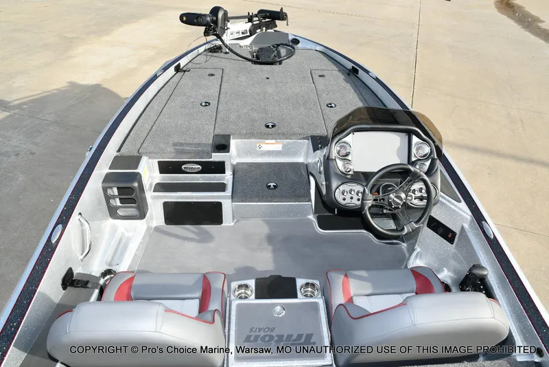 Slide: The Image of 2024 Triton 18 TRX boat interior with steering console and seating. - 31