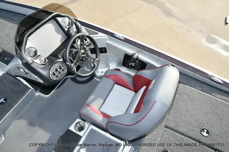 Slide: The Image of 2024 Triton 18 TRX boat interior with steering console and cushioned seat. - 32