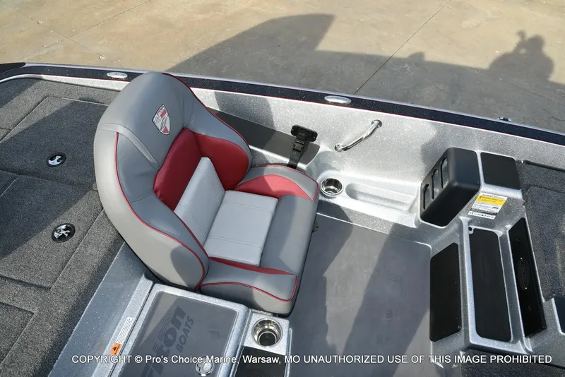 Slide: The Image of 2024 Triton 18 TRX boat interior with gray and red seating, storage compartments, and control panel. - 35
