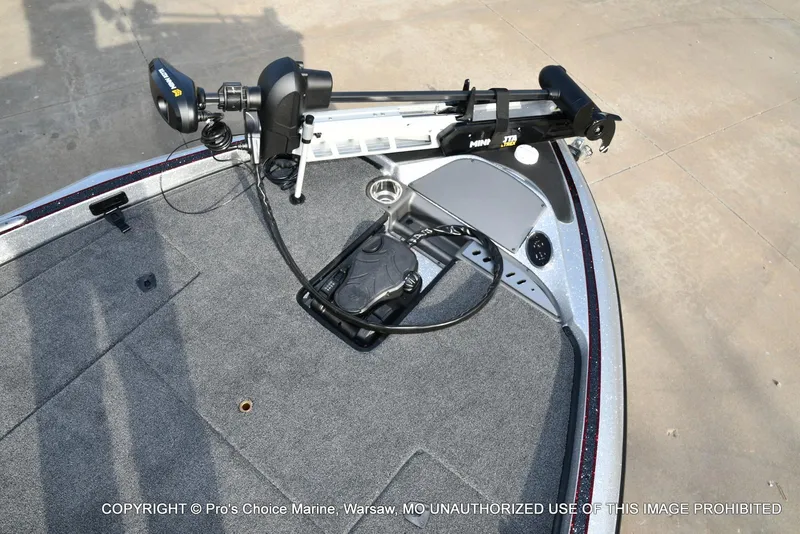 Slide: The Image of 2024 Triton 18 TRX boat deck with trolling motor and carpeted surface. - 38