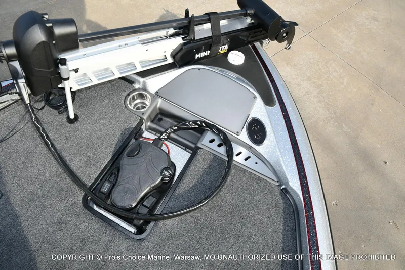 Slide: The Image of 2024 Triton 18 TRX boat deck with Minn Kota trolling motor and foot pedal controls. - 39