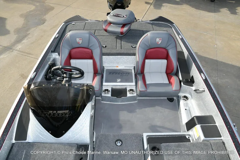 Slide: The Image of 2024 Triton 18 TRX boat interior with dual seats and steering console. - 40