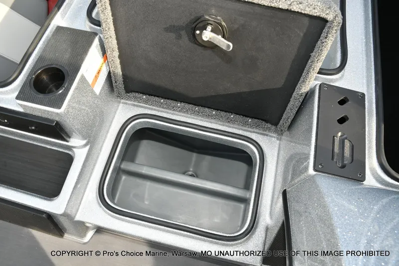 Slide: The Image of 2024 Triton 18 TRX boat storage compartment with open lid and cup holder. - 46