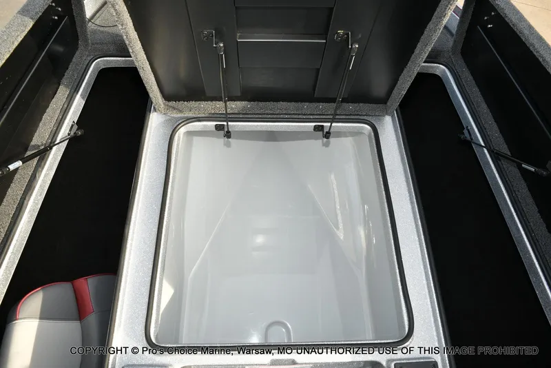 Slide: The Image of 2024 Triton 18 TRX boat storage compartment with open lid, showcasing interior space. - 47