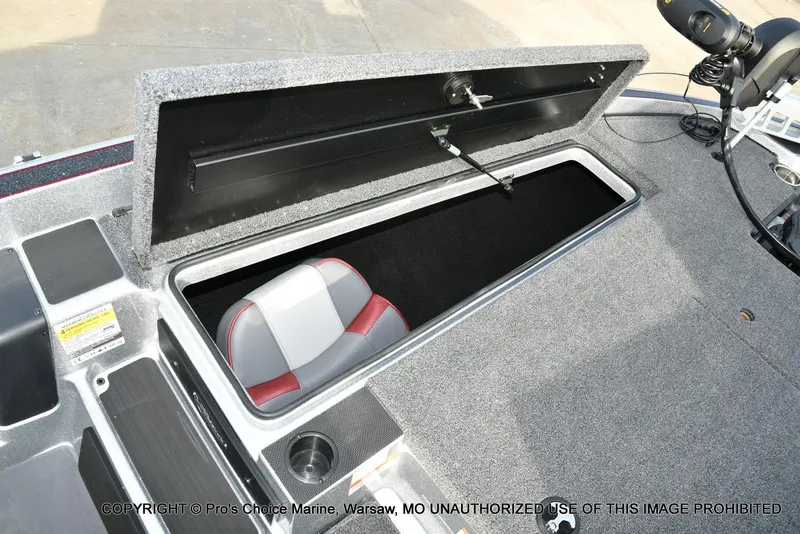 Slide: The Image of 2024 Triton 18 TRX boat storage compartment with seat and carpeted interior. - 49