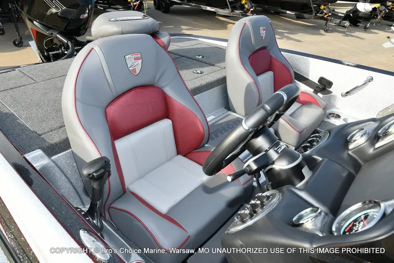 Slide: The Image of 2024 Triton 18 TRX boat interior with dual seats and steering console. - 7