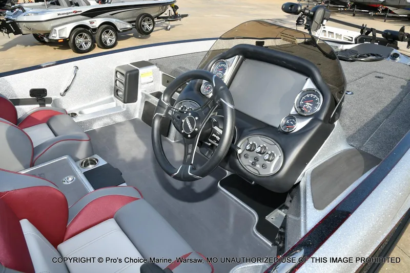 Slide: The Image of 2024 Triton 18 TRX boat interior with steering wheel and dashboard controls. - 8