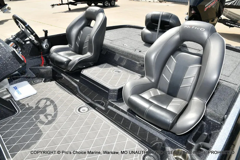 Slide: The Image of 2022 Nitro Z21 XL Pro boat interior with sleek black seating and modern dashboard. - 13
