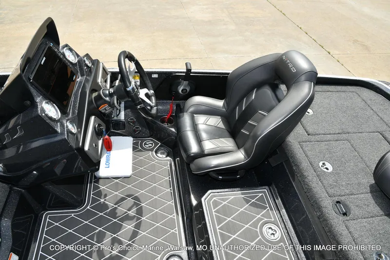 Slide: The Image of 2022 Nitro Z21 XL Pro boat interior with steering wheel and black leather seat. - 48