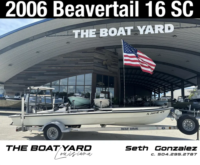 Slide: The Image of 2006 Beavertail Skiffs 16 boat at The Boat Yard, Louisiana, with American flag. - 1
