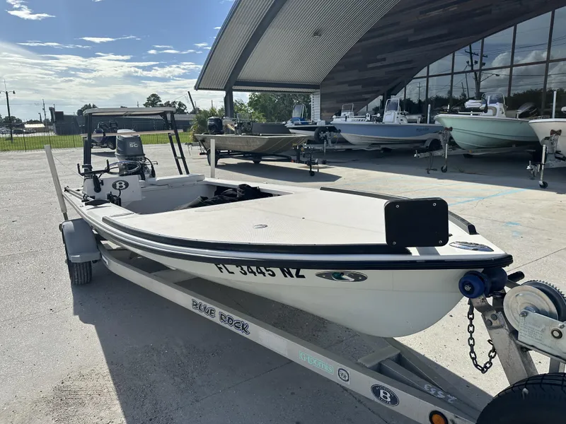 Slide: The Image of 2006 Beavertail Skiffs 16 boat on trailer, parked outside a showroom. - 3