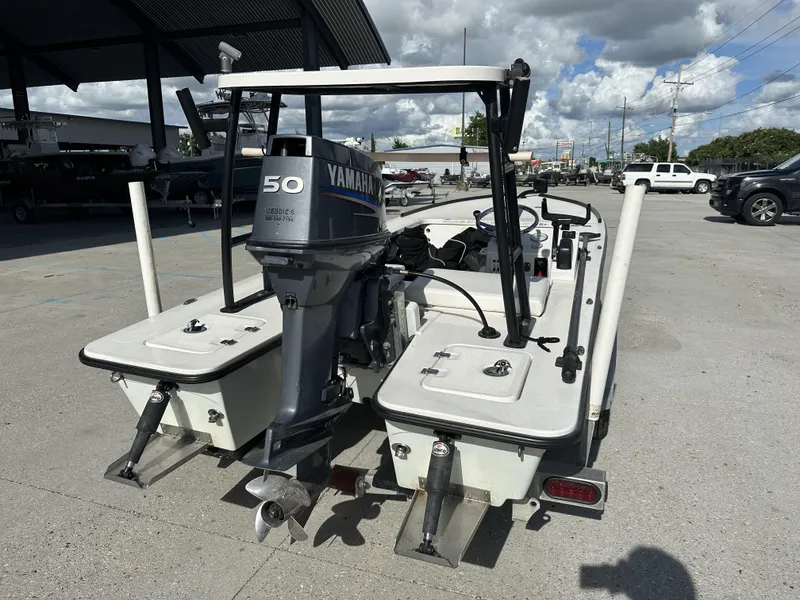 Slide: The Image of 2006 Beavertail Skiffs 16 with Yamaha 50 outboard motor, parked outdoors under cloudy sky. - 4
